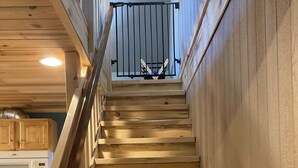 A wooden staircase with a metal railing leading to a landing. - Abundant Activities for Adventures People (Goldendale)