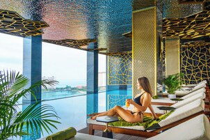 Una piscina techada, sillones reclinables de piscina
