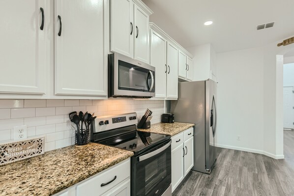 Enjoy cooking in this well-equipped kitchen with an oven, dishwasher, and microwave.
