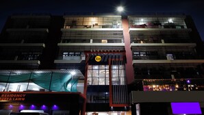 A multi-story building with a prominent 'Itsy' sign, large windows, and a red awning. - Itsy Hotels Kashi Grand, BHU (Varanasi)