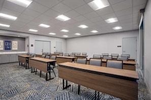 A conference room with multiple tables and chairs, a carpeted floor, and a whiteboard on the wall. - Homewood Suites by Hilton Missoula (Missoula)