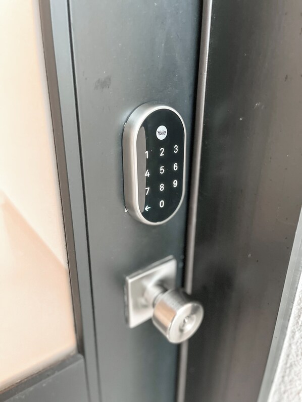 A Yale keypad lock on a door.