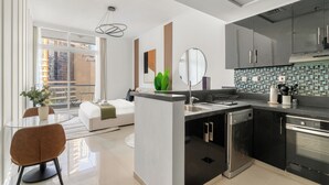A modern kitchen with a central island, black cabinets, and a stainless steel range hood. - Silkhaus Botanica Tower, Dubai Marina (Dubai)