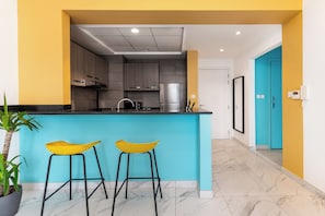 Deluxe Apartment, 1 Bedroom, Balcony | Living area | 50-inch flat-screen TV with digital channels, table football, ping pong - izzzi life Mint Holiday Home Apartments (Dubai)