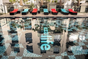Outdoor pool, pool loungers, lifeguards on site