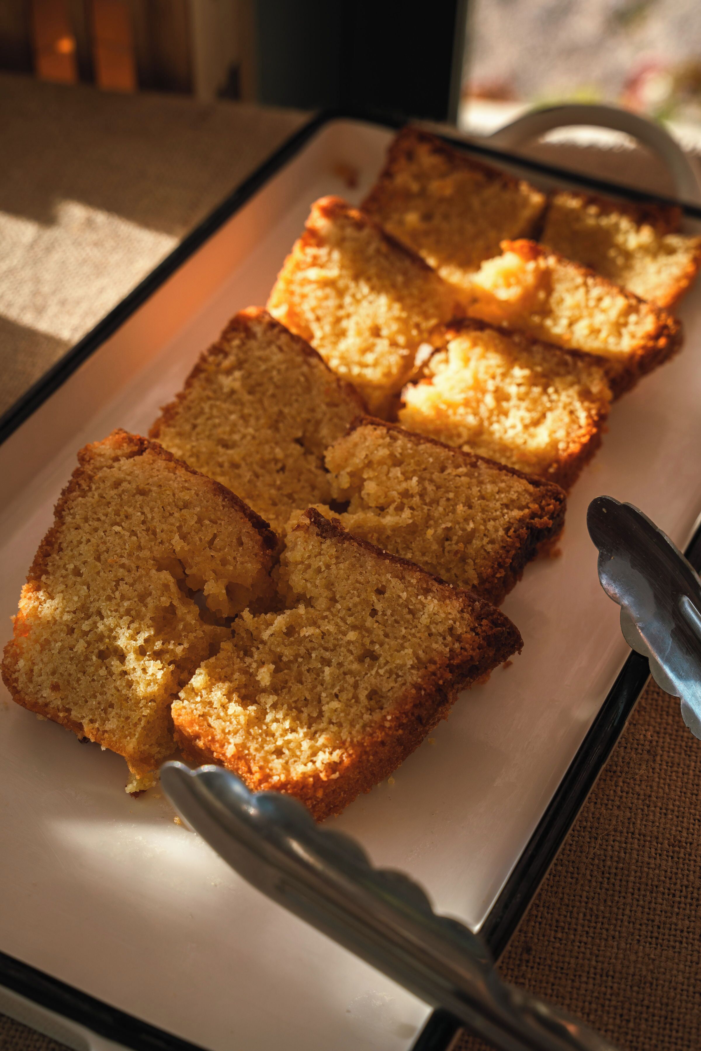 A tray of sliced cake on a white plate.