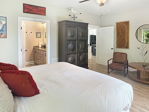 A bedroom with a large bed, a dresser, a chair, and a dining table. - Mountain-view cabin with hot tub, game room, and 3 bedrooms. Free rafting, train, zip (Bryson City)