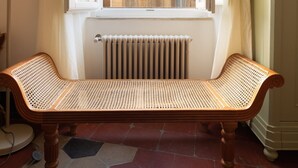 A room with a bench, a radiator, and a window overlooking a building. - Monti Charming Design Apartment (Roma)