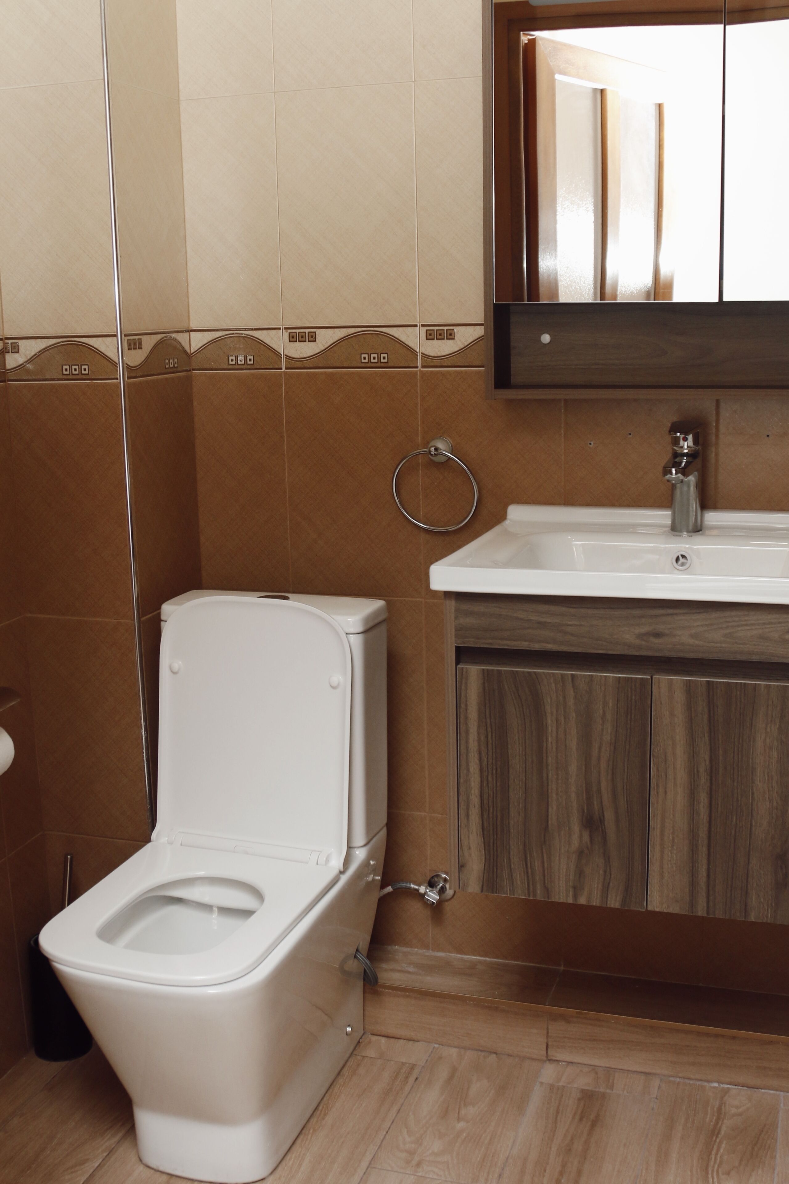 Ein Badezimmer mit Toilette, Waschbecken und Spiegel.
