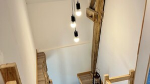 A wooden staircase with a lantern on the landing. - Maison du Périgord (La Douze)
