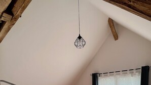 A bedroom with a bunk bed, a desk, and a hanging light fixture. - Maison du Périgord (La Douze)