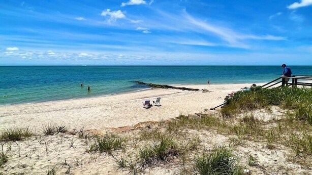 A beach with clear skies, a wooden walkway, and a few people. - Welcome To Tidal Fix! Classic Sea Side Cottage With Modern Comforts RPAM094 (Harwich)