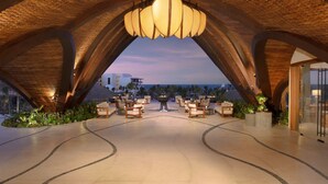 A spacious lounge area with a modern design, featuring a central fire pit and seating arrangements. - Secrets Playa Blanca Costa Mujeres - Adults Only - All Inclusive (Costa Mujeres)