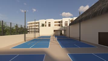 A rooftop tennis court with a building in the background.