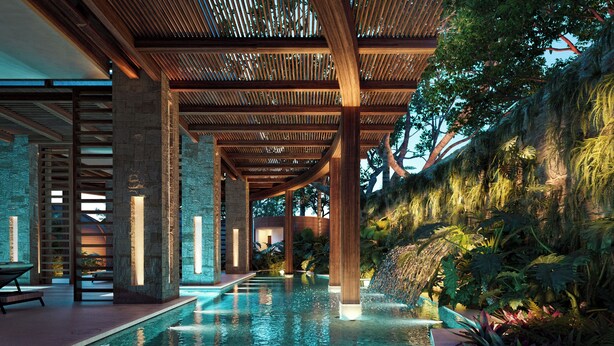 A modern indoor pool with a wooden ceiling and stone pillars, surrounded by lush tropical plants. - Secrets Playa Blanca Costa Mujeres - Adults Only - All Inclusive (Costa Mujeres)