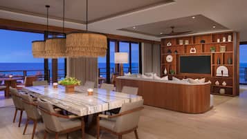 A modern dining area with a marble table, chairs, and a central island with a sofa.
