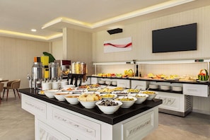 A buffet setup with various food items and a coffee station. - Ramada By Wyndham Cesme (Cesme)