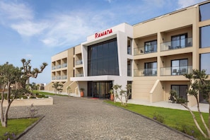 A modern building with a flat roof, large windows, and a sign reading 'RAMADA'. - Ramada By Wyndham Cesme (Cesme)