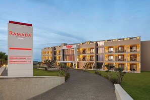 A modern hotel with a sign indicating amenities such as a car park and entrance.