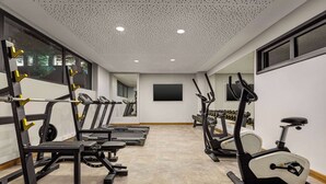 A gym with various exercise equipment, including treadmills and weight machines.