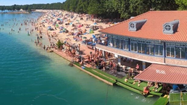 A beachside hotel with a large pool, outdoor seating, and a restaurant area. - 2 Bedroom Apartment in Haren (Ems) (Haren (Ems))