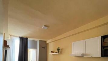 A compact living space with a kitchenette, a dining area, and a seating area.