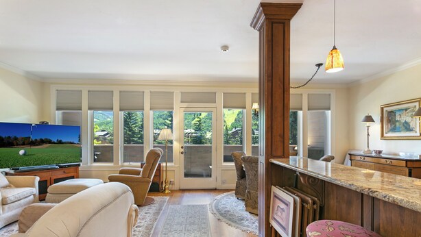 A spacious living room with a pool table, comfortable seating, and large windows offering a view of a green landscape. - Mtn Views a Short Walk to Lionshead Gondola, SV22A (Vail)