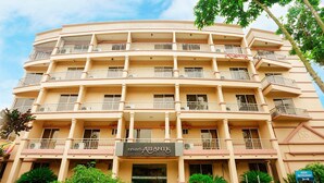 A multi-story hotel with balconies, a sign for 'resort ATLANTIS', and a sign for 'AQUA RESTAURANT'. - Resort Atlantis (Savar)