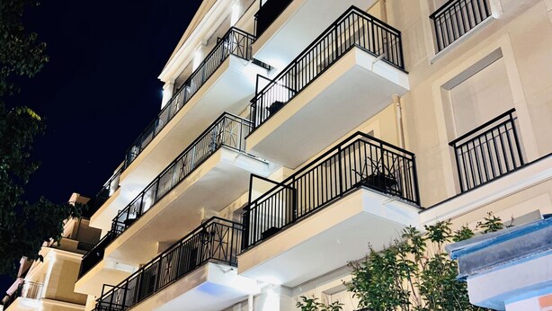 A multi-story building with balconies, a gated entrance, and a visible address sign. - 156 Av. Pasteur b1 (Le Blanc-Mesnil)