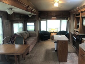 Cozy living space with a kitchenette, dining table, and comfortable seating area.