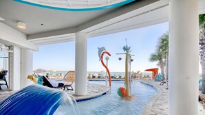 A pool area with a water slide, lounge chairs, and a view of the beach. - Amazing Oceanview Condo on the 17th Fl- 2 Balconies (Myrtle Beach)