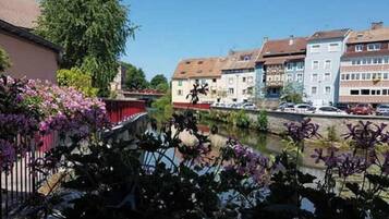 Une vue sur la rivière, avec des bâtiments et des voitures garées.