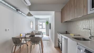 Una cocina moderna con lavavajillas, un lavabo y armarios de madera.