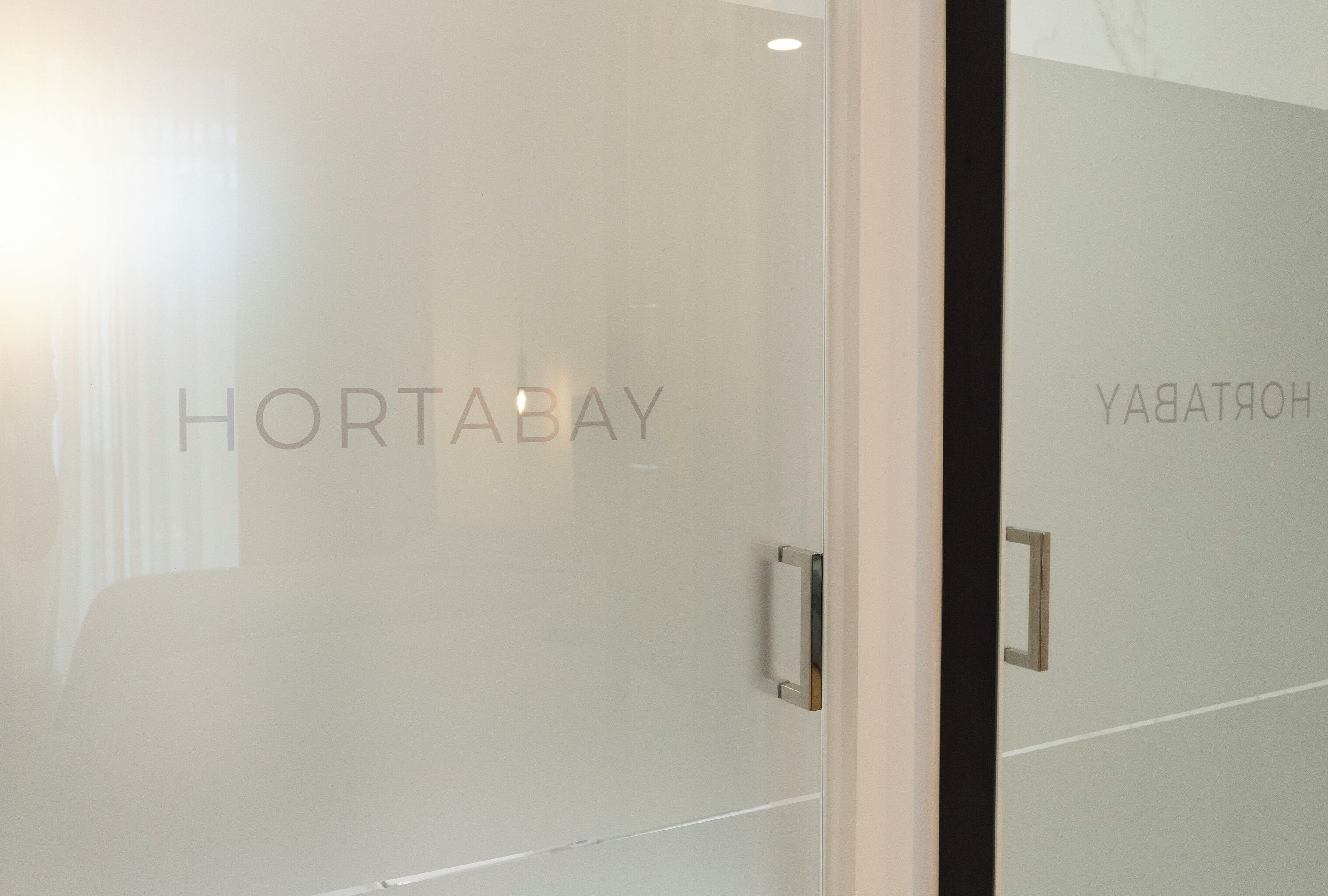 Una puerta de vidrio con las palabras "HORTABAY" y "HORTABAY".