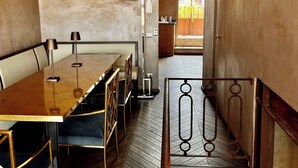 A dining area with a wooden table and chairs, a ceiling fan, and a view of the outside. - Florence from above (Firenze)