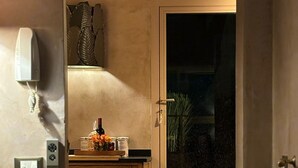 A kitchen with wooden cabinets, a countertop, and a window with a view of the night sky. - Florence from above (Firenze)