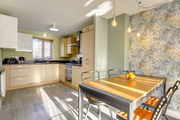 Enjoy meal preparation at the central island with oven and stovetop, complemented by a sleek countertop.