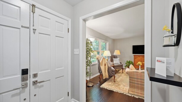 A hallway with white doors, a lamp, a sofa, and a rug. - Greensboro Golf Getaway - 9 Mi to Downtown! (Greensboro)