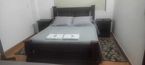 Cozy retreat with a single bed, two bedside tables, and a patterned rug.