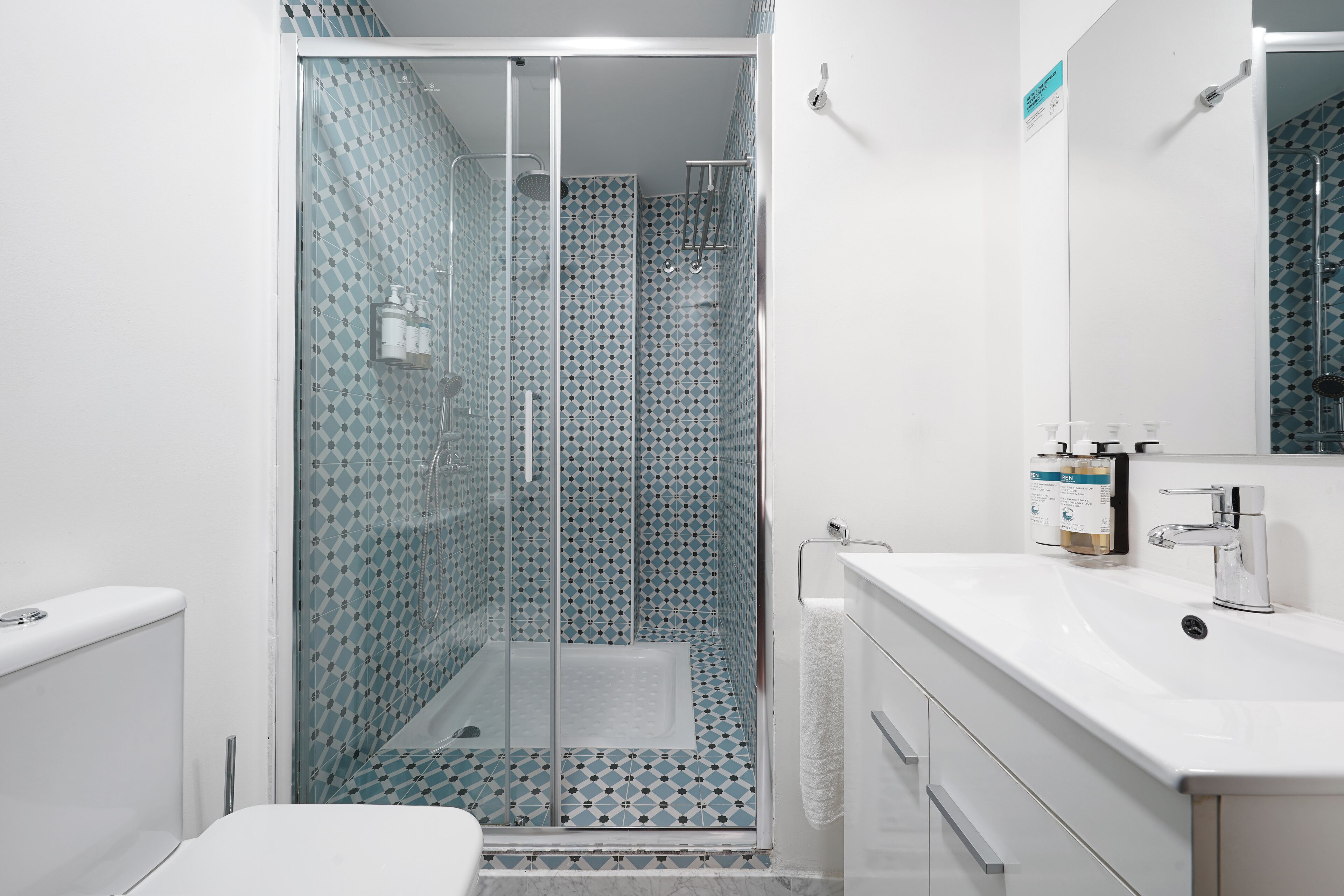 Shower, designer toiletries, hair dryer, towels