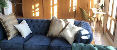Relax in this stylish living room with a sofa, coffee table, and wardrobe, offering a view of the outdoors.