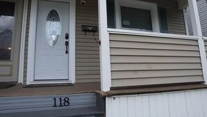 A house with a white front door, a small porch, and a mailbox. - "Serene Escape: Leave Worries Behind"
 (Wilkes-Barre)