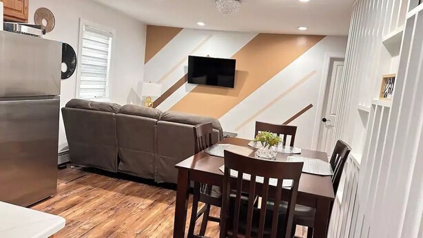 A compact living space with a kitchen, dining area, and a sofa. - "Serene Escape: Leave Worries Behind"
 (Wilkes-Barre)