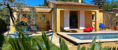 Relax by the serene pool surrounded by lush greenery and tranquil surroundings.