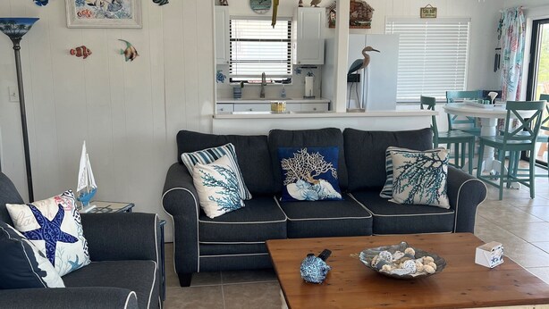 A living room with a sofa, coffee table, and decorative pillows.