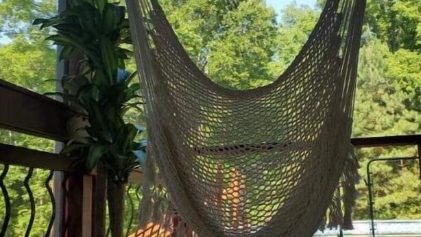 A hammock hanging on a balcony with a view of trees and a wooden deck. - Large Private Home Near Charlotte Sleeps 15  Workspaces and Land - NO PETS (Dallas)