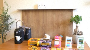 A wooden table with a coffee maker, Twinings Earl Grey tea, Twinings fruit tea, Twinings super green tea, and Twinings tea bags. - Charming Spacious Central Apartment (Edinburgh)