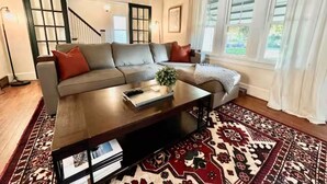 A living room with a sofa, coffee table, and patterned rug. - The Portage Place: 3BR 2 mi from ND w/ king suite (South Bend)