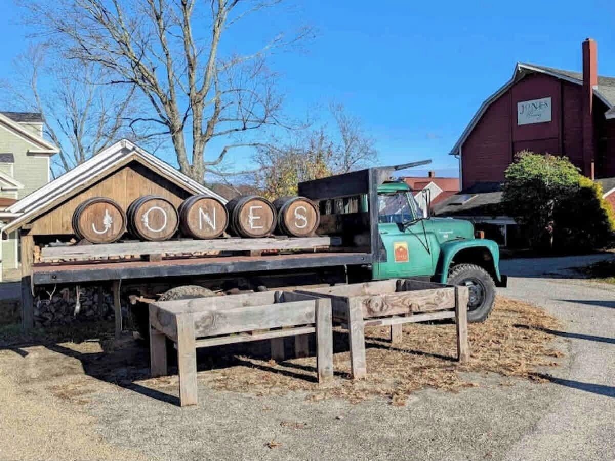 A wooden sign with the name 'JONES' and wooden barrels.