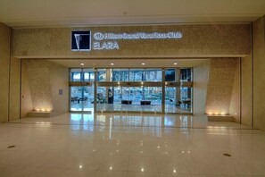 The entrance to the Hilton Grand Vacations Club FLARA with a modern glass facade and a sign above the entrance. - Las Vegas | Pool & Strip Access | Vegas Lifestyle Stay (Las Vegas)
